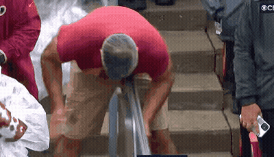 Man In Red Shirt Standing On Stairs GIF