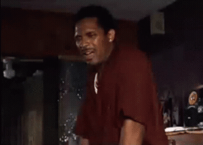 Man In Red Shirt Standing With Hands Up GIF