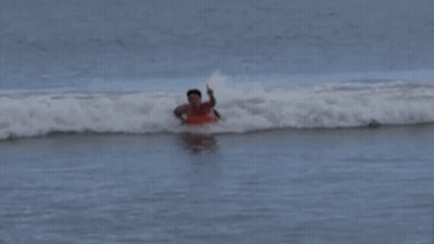 Man In Red Shirt Surfing Ocean GIF