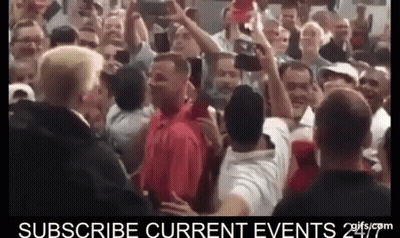 Man In Red Shirt Surrounded By Crowd GIF