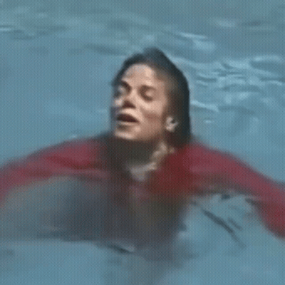 Man In Red Shirt Swimming With Mouth Open GIF