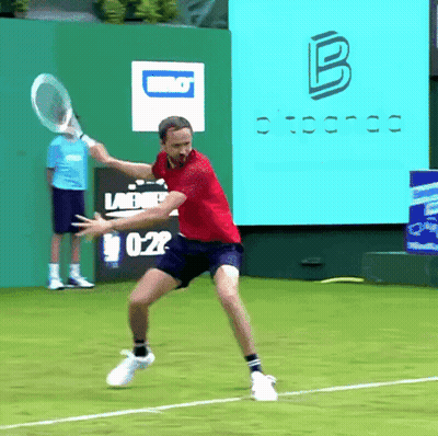 Man In Red Shirt Swinging Tennis Racket GIF