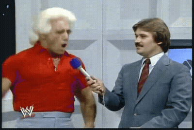 Man In Red Shirt Talking Into Microphone GIF