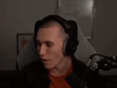 Man In Red Shirt Talking Into Microphone GIF