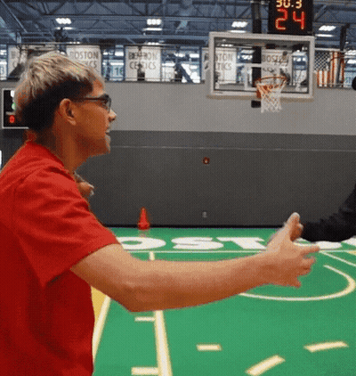 Man in Red Shirt Talking to Another Man on Basketball Court Score 24 to 30