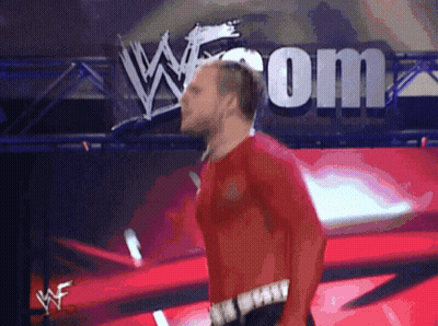 Man In Red Shirt Walking In Front Of W.com Sign GIF
