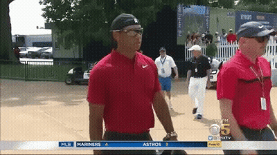 Man In Red Shirt Walking Past MLB Advertisement GIF