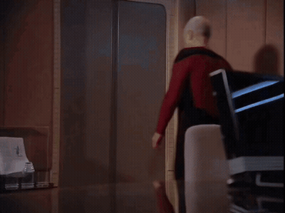 Man In Red Shirt Walks Into Room GIF