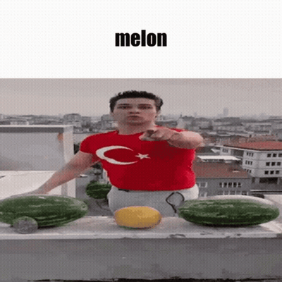 Man In Red Shirt With C Pointing To Melon GIF