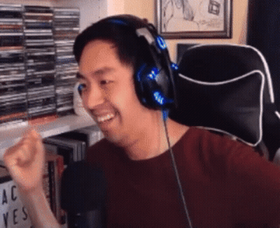 Man In Red Shirt With Headphones Sitting GIF