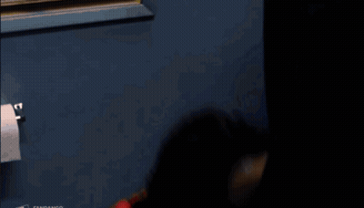 Man In Red Shirt With Necklace Looking Up GIF