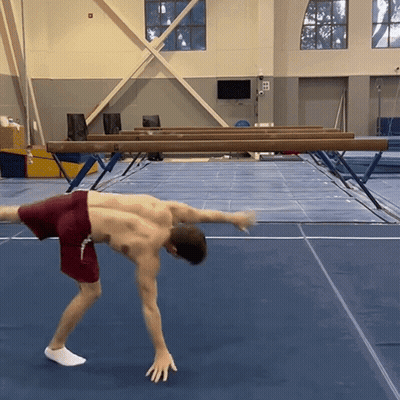 Man In Red Shorts Doing Handstand GIF