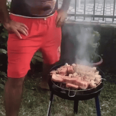 Man In Red Shorts Grilling Meat GIF