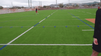 Man In Red Shorts On Soccer Field With Mountains GIF