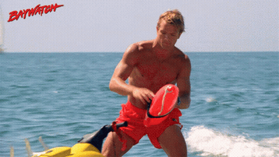 Man In Red Shorts Riding Jet Ski Ocean Baywatch GIF