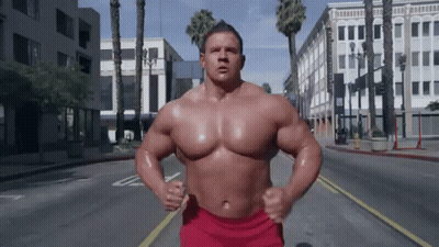 Man In Red Shorts Running Down Street GIF