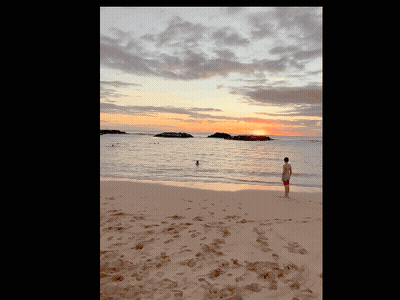 Man In Red Shorts Watching Sunset On Beach GIF