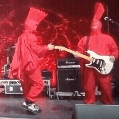 Man In Red Singing Into Microphone On Stage GIF