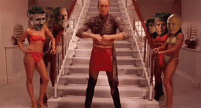 Man In Red Skirt Surrounded By Women In Bikinis GIF