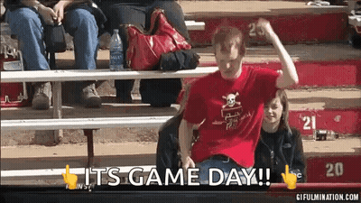 Man In Red Skull Shirt Sitting On Bleacher Saying It's Game Day GIF
