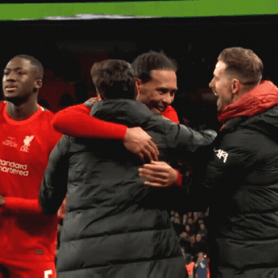 Man In Red Standard Chartered Shirt Hugging Another Man GIF