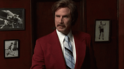 Man In Red Suit And Blue Tie Holding Toothbrush GIF