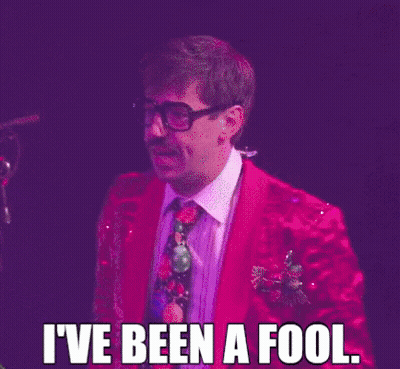 Man In Red Suit And Tie At Microphone GIF