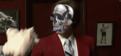 Man In Red Suit And Tie Holding Gun Pointing At Food GIF