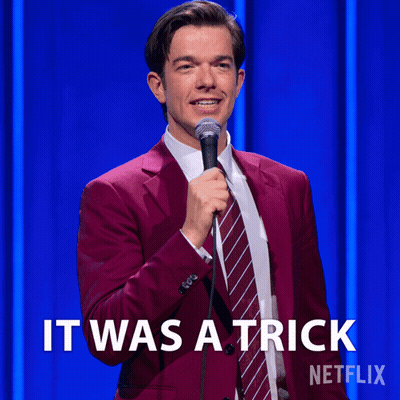 Man In Red Suit And Tie Holding Microphone Saying It Was A Trick GIF