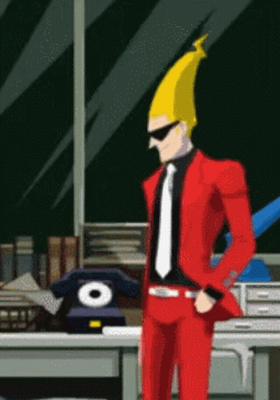 Man In Red Suit And Tie Standing At Desk GIF