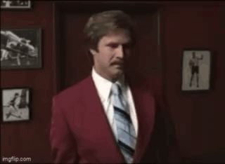 Man In Red Suit And Tie With Hello Kitty Bow GIF