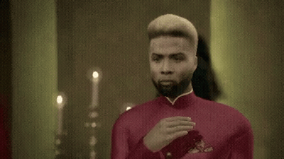 Man In Red Suit At Mirror GIF