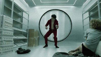 Man In Red Suit Dancing In Front Of Circle GIF