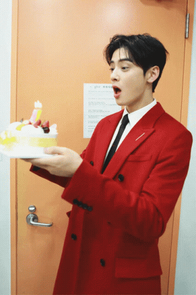 Man In Red Suit Holding Birthday Cake GIF