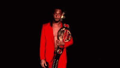 Man In Red Suit Holding Championship Belt GIF