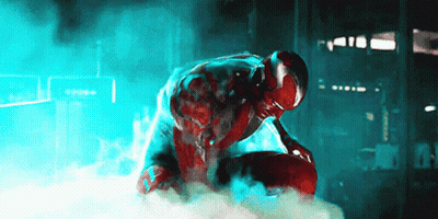 Man In Red Suit Kneeling In Dark Room With Smoke GIF