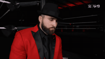 Man In Red Suit Next To Woman In White Jacket USA GIF