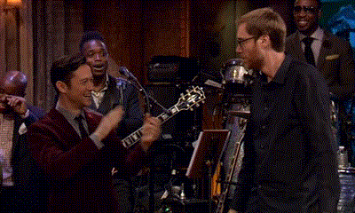 Man In Red Suit Playing Guitar For Group GIF