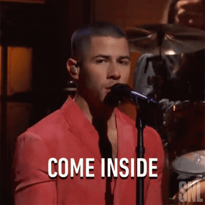 Man In Red Suit Singing Into Microphone Saying Come Inside GIF