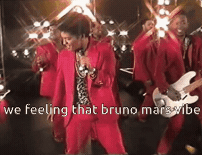 Man In Red Suit Singing Into Microphone With Guitarists GIF