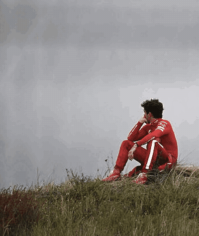 Man In Red Suit Sitting On Hill GIF