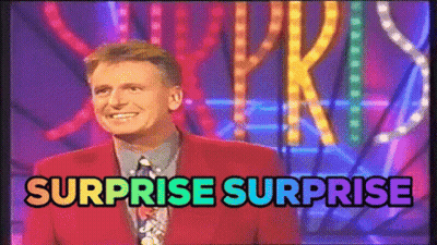 Man In Red Suit Standing In Front Of Surprise Surprise Sign GIF