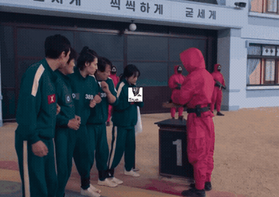 Man In Red Suit With Green Uniforms GIF