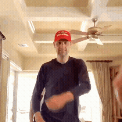 Man In Red Supreme Hat Dancing In Living Room GIF