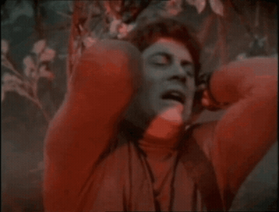 Man In Red Sweater Covering Ears GIF