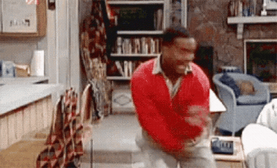Man In Red Sweater Dancing In Front Of Fireplace GIF