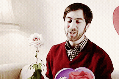 Man In Red Sweater Holding Rose And Heart GIF