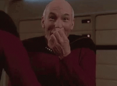Man In Red Sweater Laughing Hands Over Mouth GIF