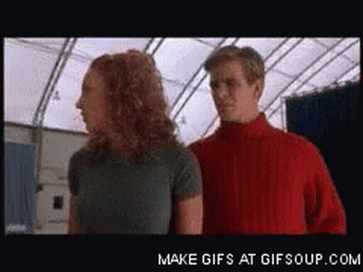 Man In Red Sweater Next To Woman GIF