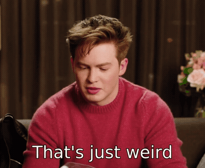 Man In Red Sweater Saying That's Weird GIF